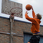 Homme qui met un dunk au sur un panier de Basketball